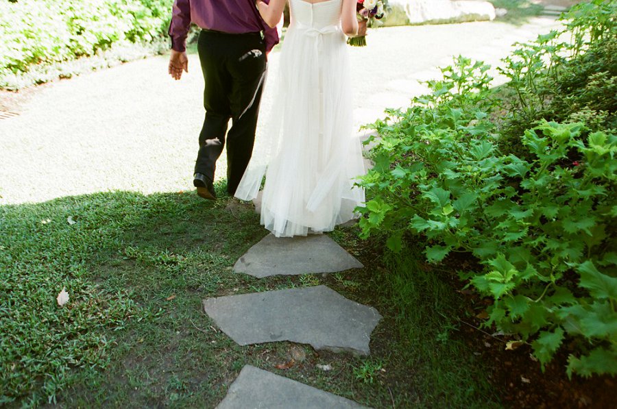 Bride walking at Dallas arboretum wedding.