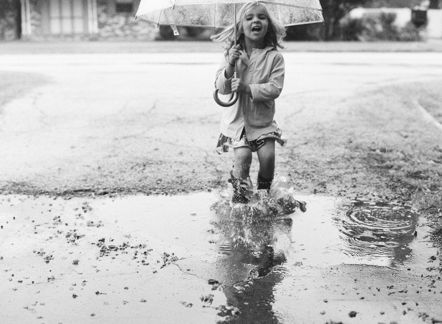 Girl plays in Dallas storm. Captured on Ilford Delta 3200.
