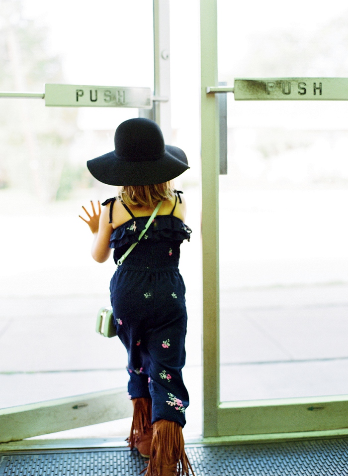 Dallas photographer captures girl walking out door.