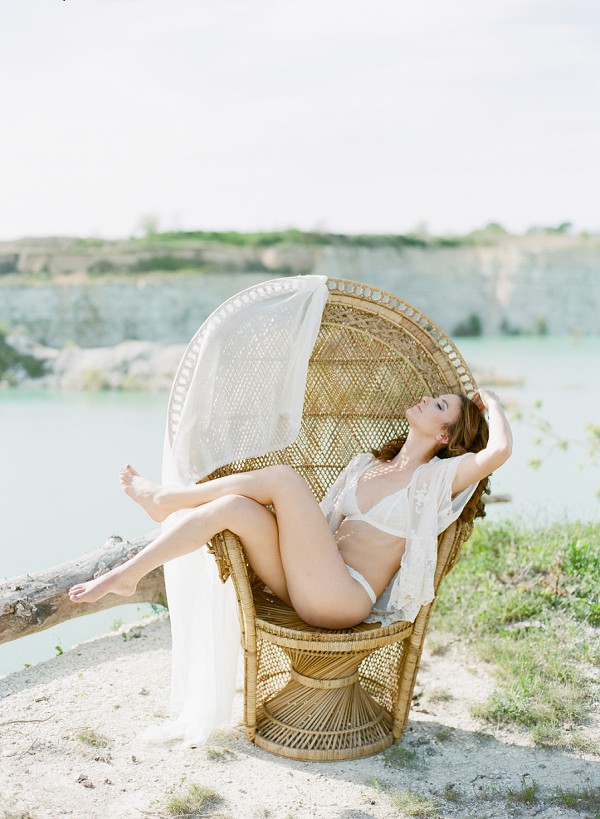 Meghan's Outdoor Boudoir photo shoot, this photo features Meghan posing on a wicker chair.